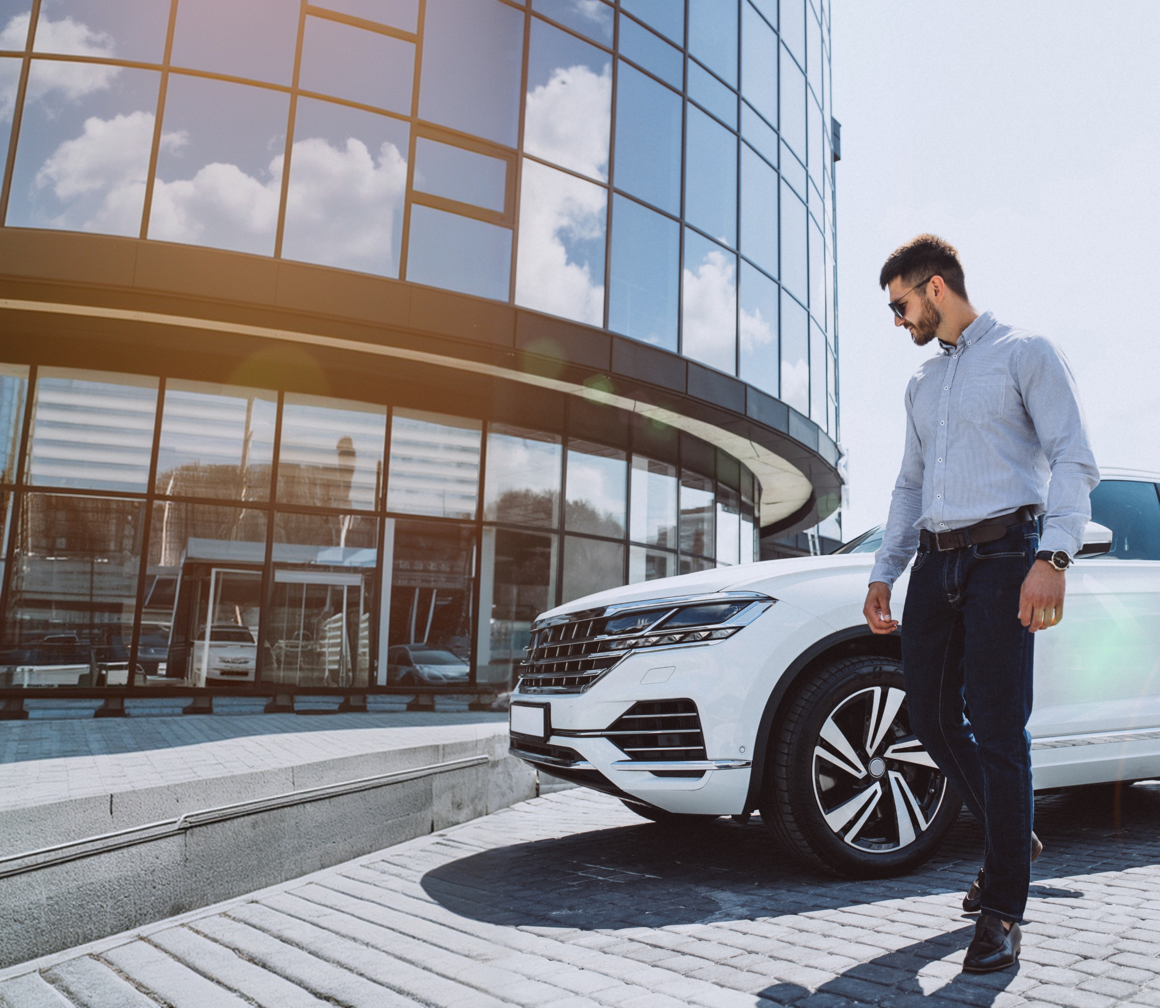 Men stand front of Office with his Car